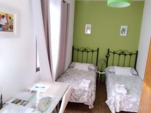 Łóżko lub łóżka w pokoju w obiekcie Casa Nazario Duplex