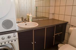 a bathroom counter with a sink and a mirror at Hotel Nuka in Ilulissat