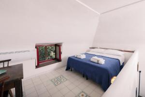 a bedroom with a bed with two towels on it at MAMMAAMIIIAA!!!!! Exclusive TERRACE in Chiaiolella in Procida