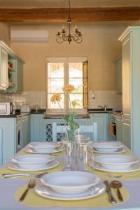 a kitchen with a table with white plates and silverware at Razzett Ziffa in Victoria