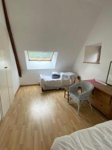 a attic room with two beds and a window at Spacious Longere,heated swimming pool, idyllic setting, Southern Brittany, FR in Pluherlin