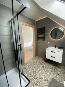 a bathroom with a shower and a sink and a mirror at Nad Doliną Krutyni in Ukta +42 photos