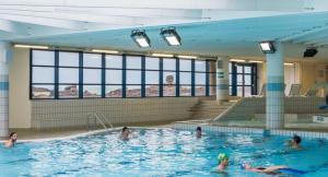 a group of people swimming in a swimming pool at Les Balcons du Trégor, Chambres d'hôtes in Lannion