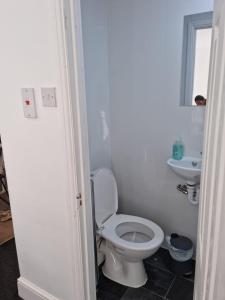 a bathroom with a white toilet and a sink at Immaculate 4-Bed House in Southampton in Southampton