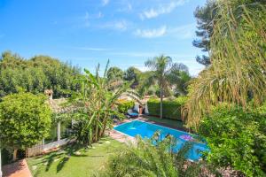 an image of a backyard with a swimming pool and trees at Las Rotas KD in Denia