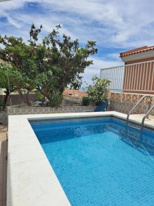 a swimming pool in the middle of a building at Spacious Apartment in Villa Noelia Benalmadena with Private Pool, Garden & Parking in Benalmádena