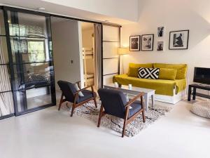 a living room with a couch and a table and chairs at The Quay Amsterdam - FREE PARKING in Amsterdam