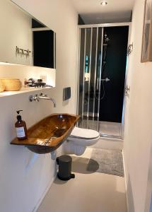 a bathroom with a wooden sink and a toilet at The Quay Amsterdam - FREE PARKING in Amsterdam