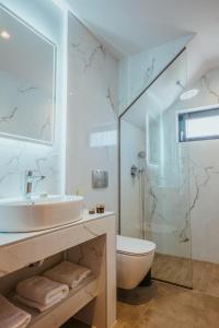 a bathroom with a sink and a toilet and a shower at Anemmaro Villa 1 in Crete in Gournes