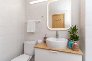 a white bathroom with a sink and a mirror at Sunny Apartment Alva Park in Lloret de Mar +31 photos