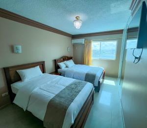 Postel nebo postele na pokoji v ubytování Apart Hotel Hamilton