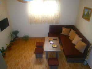 a living room with a couch and a table at Aygestan Comfort Holiday Home in Yerevan