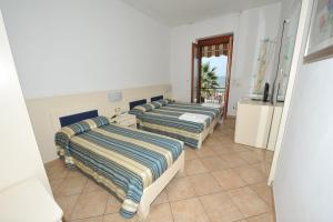 Postel nebo postele na pokoji v ubytování B&B Anna Lungomare
