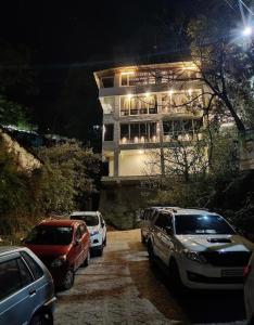 a group of cars parked in front of a building at The White House in Nainital