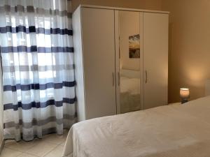 a bedroom with a bed and a cabinet at Lindenhof WE 5 in Dahme