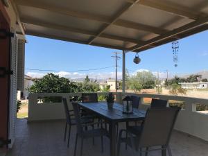 a table and chairs on a patio with a view at Pazinos/Neveli Cottage in Galangádhos