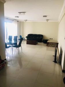 a living room with a couch and a table and chairs at Edificio Granada in Santa Cruz de la Sierra