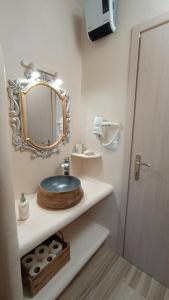 a bathroom with a sink and a mirror at Enigma Boutique Houses Koxyli in Marmarion