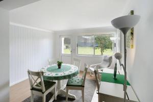 a dining room with a green table and chairs at Casa da Batalha in Ponta Delgada