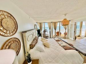a bedroom with a large bed with a view of the ocean at Relax'n'Retreat @ BellaView603 in Daytona Beach