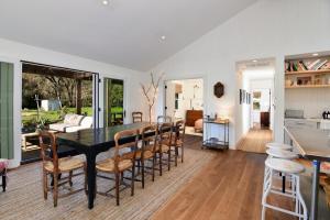 a dining room with a black table and chairs at Healdsburg Homestead A Wine Country Escape in Healdsburg