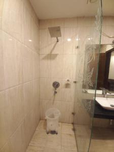 a bathroom with a shower with a toilet in it at HOTEL BLUE ORCHID - A 3 STAR HEAVEN IN Tricity in Zirakpur