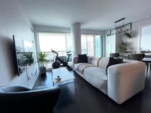 a living room with a couch and some chairs at TORONTO SKYLINE VIEW CONDO LIBERTY VILLAGE (Private Room & Bath) in Toronto