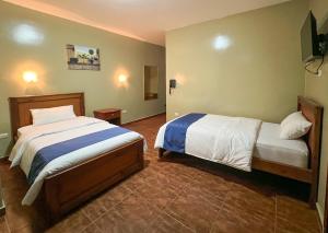 Postel nebo postele na pokoji v ubytování Apart Hotel Hamilton