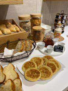 a table topped with plates of bread and other food at Kyriad Montpellier Est - Lunel in Lunel