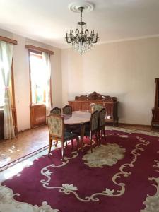 a dining room with a table and chairs and a chandelier at Spacious house for whole family in Kutaisi