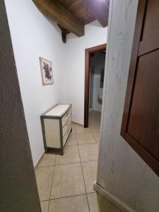a hallway with a dresser and a toilet in a room at L'Antica Torre Caralis Holiday in Cagliari