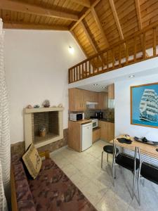 a kitchen and living room with a table and a dining room at Garden House No 2 in Plomari