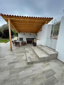 an outdoor patio with a wooden pergola at Garden House No 2 in Plomari +30 photos