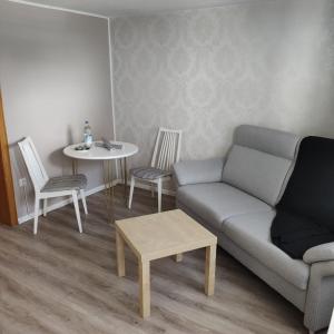 a living room with a couch and a table and chairs at FeWo Altstadt BL in Bad Laasphe