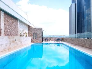 a swimming pool on the roof of a building at Elegant and comfy apartment in Westlands, Nairobi in Nairobi