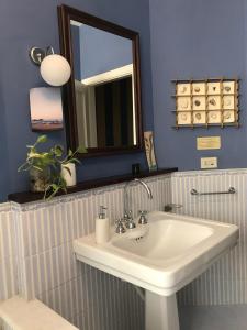 a bathroom with a white sink and a mirror at La Combriccola in Santarcangelo di Romagna