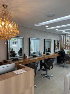 a salon with two desks with mirrors and chairs at Apartamento Bora Bora in Rio de Janeiro