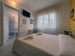 Postel nebo postele na pokoji v ubytování Affittacamere I Gigli di Mare