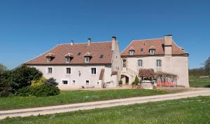 a large white building with a brown roof at Bambi in Asquins