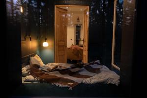 a bed in a room with a mirror at Tu, Tam i Tamten Domek in Wojtyniów +90 photos
