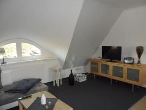 a living room with a bed and a flat screen tv at Grete in Wieck