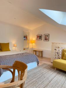 a bedroom with a bed and a couch and a chair at Beach & City - Trafaria in Trafaria