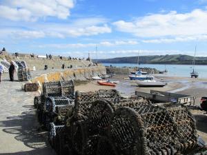 a group of boats sitting on the beach at Ty Cerrig seaside Annexe, New Quay in New Quay