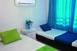 Postel nebo postele na pokoji v ubytování Ayenda Hotel Roisa