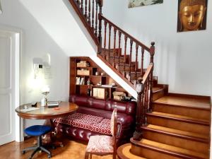 a living room with a staircase with a table and a chair at Nomad Villa Santa Fe in Las Palmas de Gran Canaria