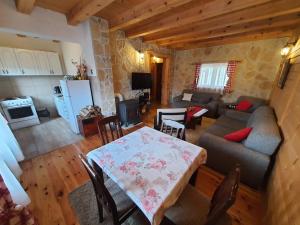 a kitchen and living room with a table and a couch at Vacation Home Andjelic in Žabljak