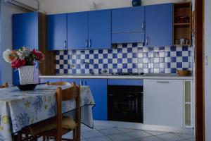 A kitchen or kitchenette at Appartamenti Costa - BUDONI SWEET HOME
