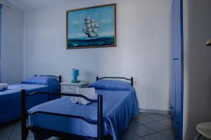 A bed or beds in a room at Appartamenti Costa - BUDONI SWEET HOME