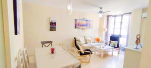 a living room with a couch and a table at Apartamento Tres Carabelas II, AC, Wifi, Parking in Sanlúcar de Barrameda