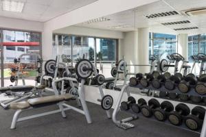 a gym with a lot of weights and machines at Cozy Ocean View Apartment in Cape Town